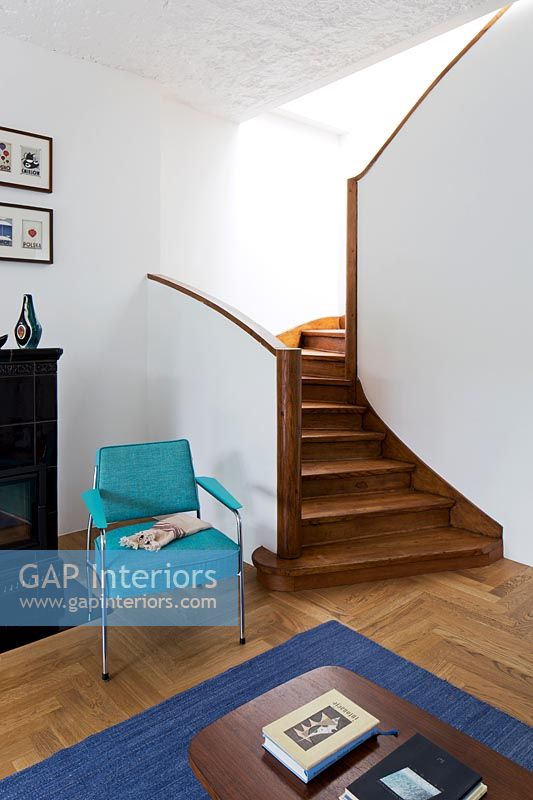 Wooden stairs and turquoise armchair