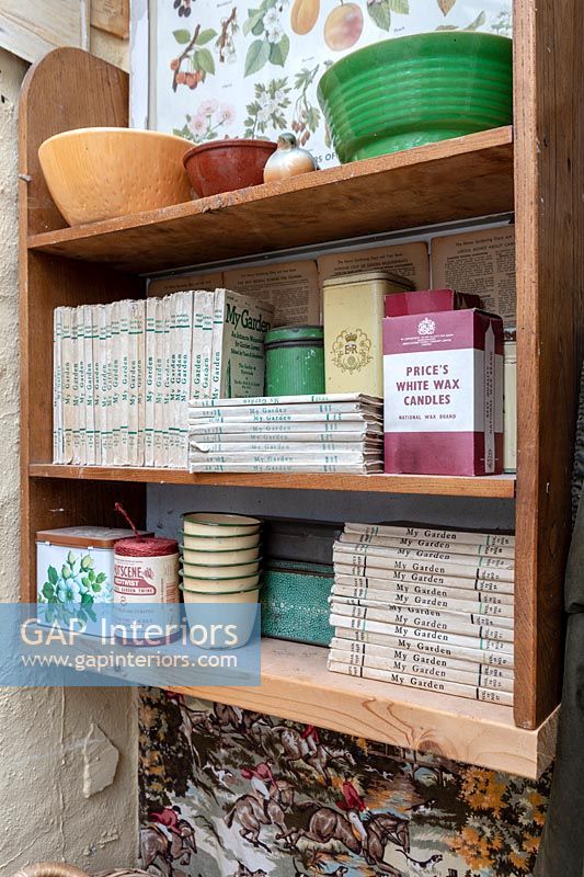 Cottage gardening books on shelving 