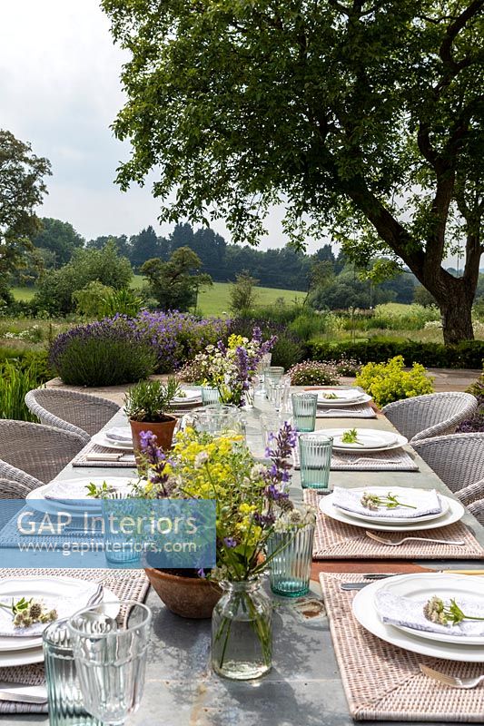 Outdoor dining table in country garden 