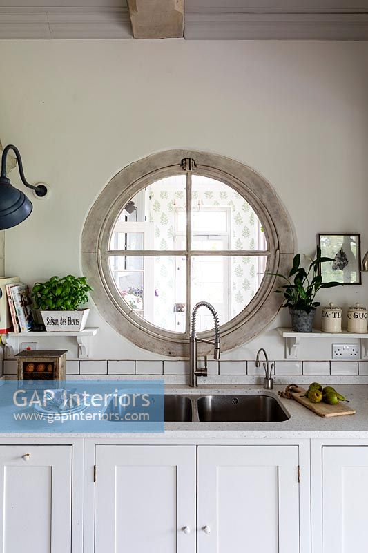 Porthole window above kitchen sink