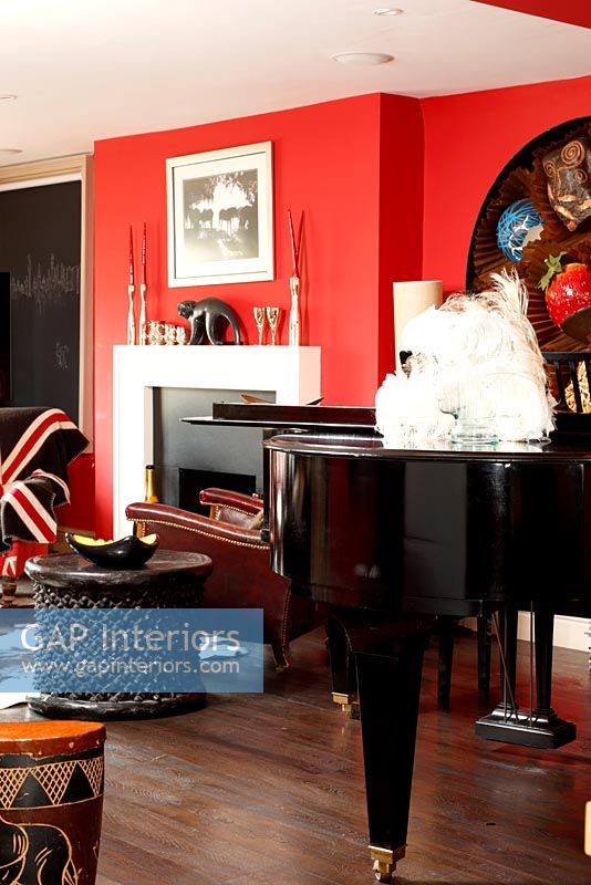 Red living room with piano 