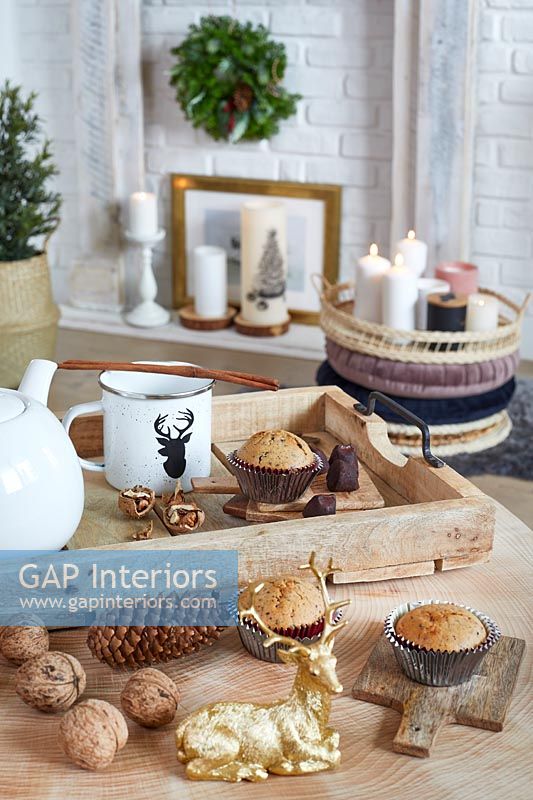 Christmas decorations and cakes on side table in country living room 