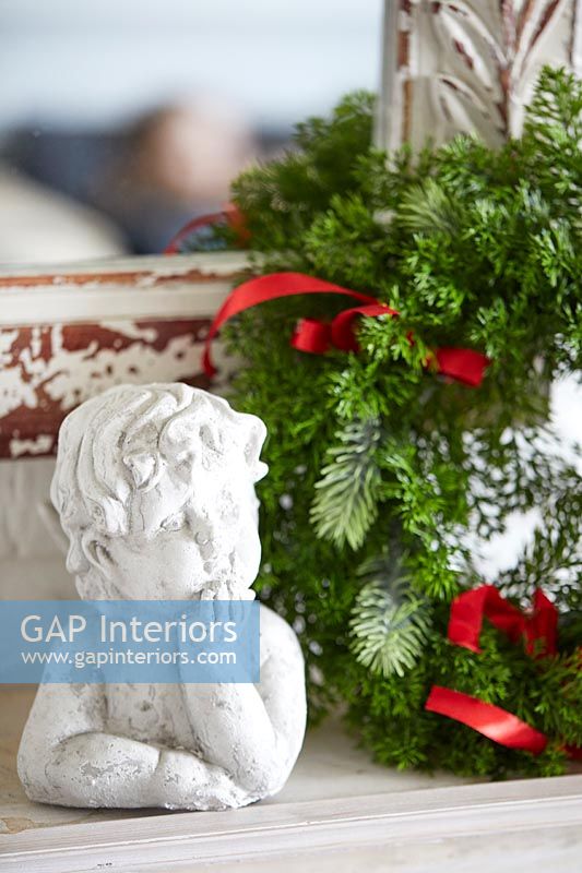 Cherub and wreath on mantelpiece - Christmas decorations 