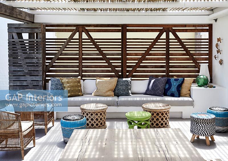Outdoor living area - covered terrace with built in sofa seating 