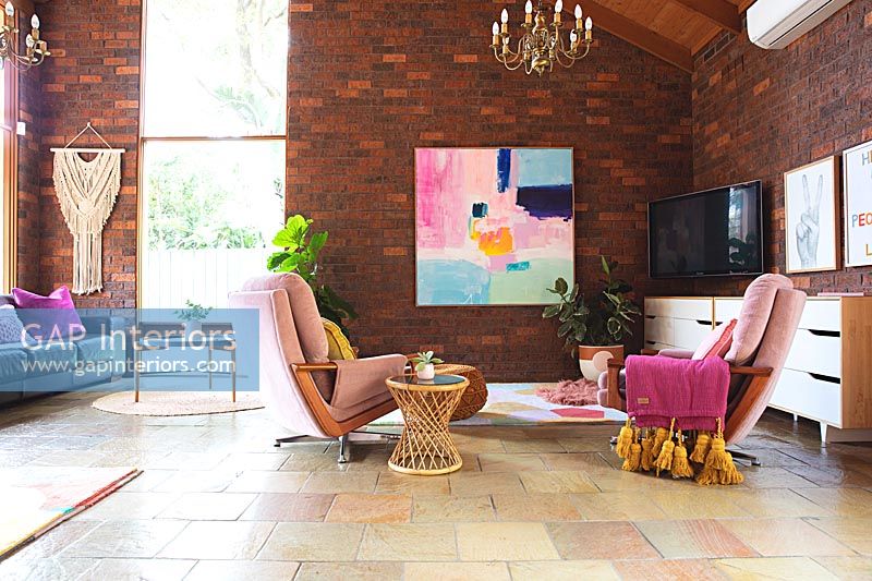Large modern living room with exposed brick walls and stone flooring 