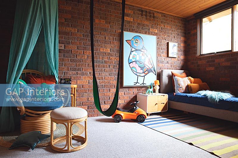 Modern childrens room with toys and fabric swing 