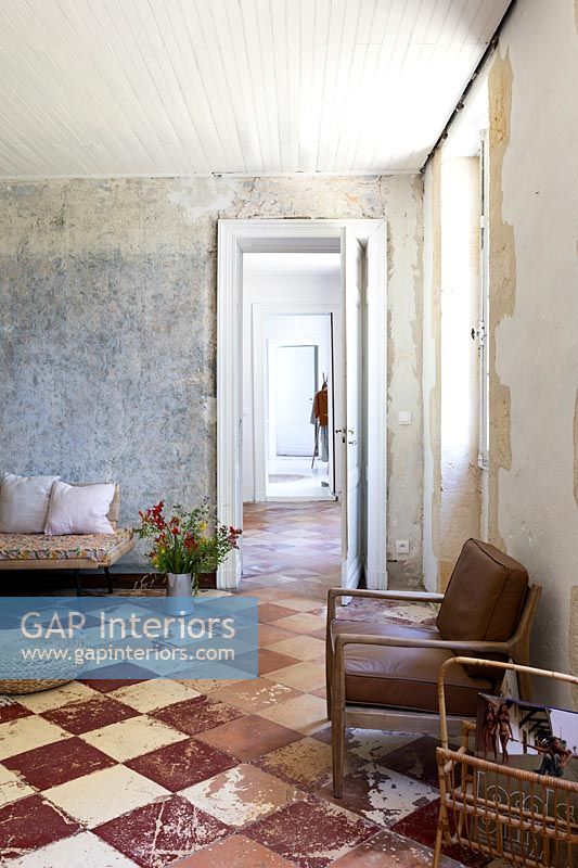 View along corridor from country living room with bare plaster walls 