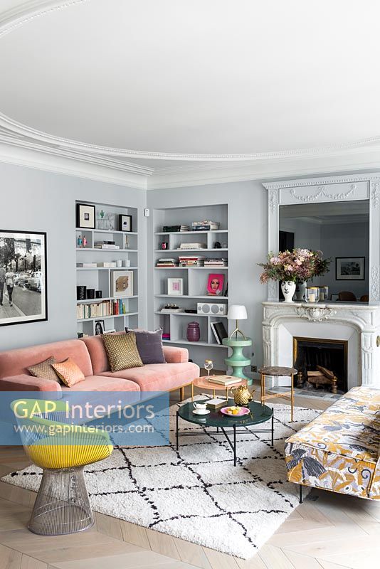 Grey painted walls and modern furniture in living room with period details 