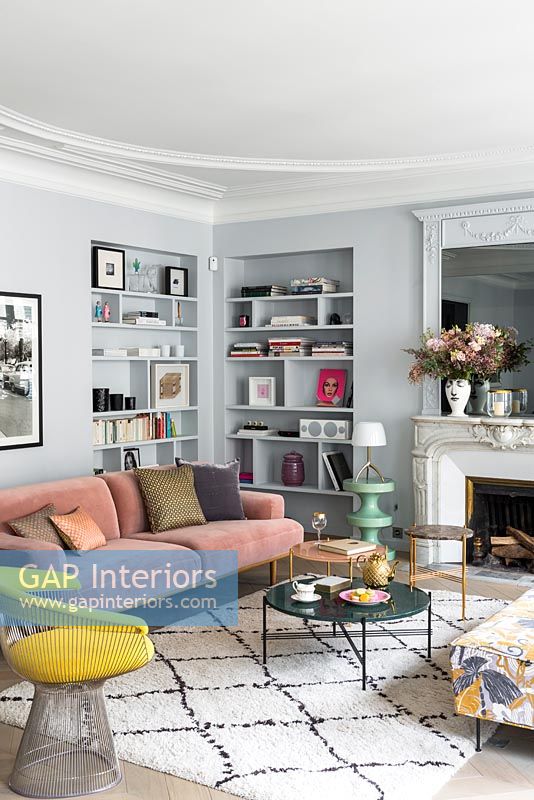 Grey painted walls and alcove shelving in modern living room 