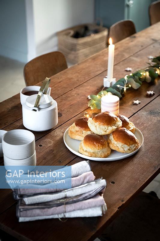 Buns on wooden dining table decorated for Christmas 
