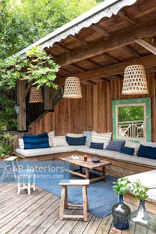 Outdoor living area in wooden shelter 