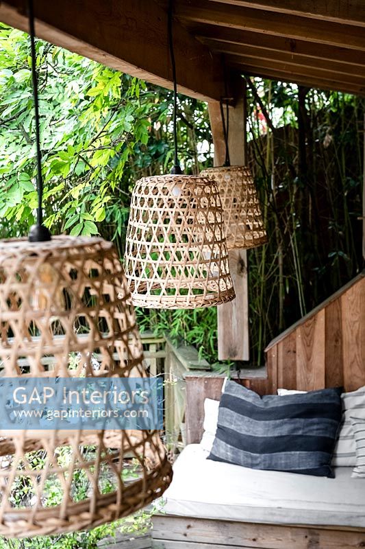Wicker lampshades on pendant lights in outdoor living room area