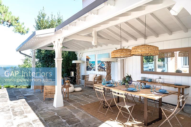 Outdoor dining area in shade of covered terrace 