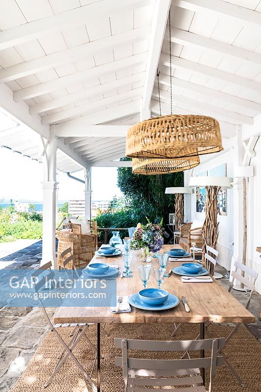 Outdoor dining area on covered terrace with sea views 