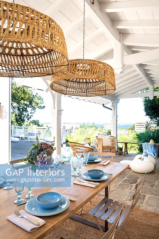 Outdoor dining area on covered terrace with sea views 