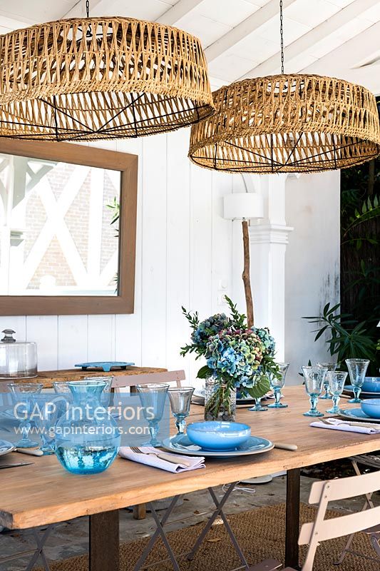 Blue glassware and crockery on outdoor dining table 