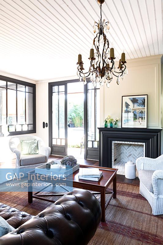 Classic living room with open French windows in summer 