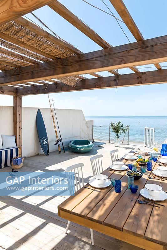 Dining table on decking overlooking the sea 