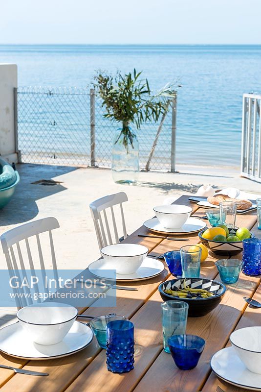 Outdoor dining area with view of beach and sea 