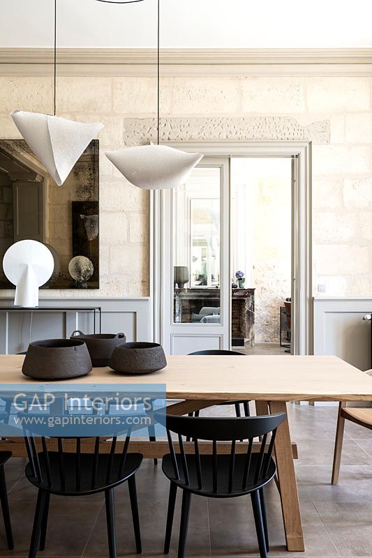 Modern dining room with exposed stone walls 
