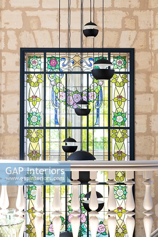 Modern pendant lights and stained glass window 