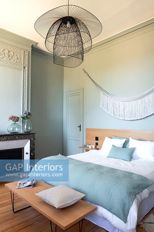 Aqua blue painted classic bedroom with modern light