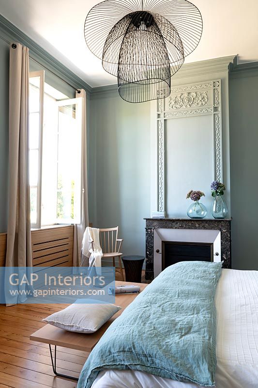 Aqua blue painted modern bedroom with period features 