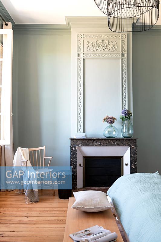 Aqua blue painted country bedroom with period features 