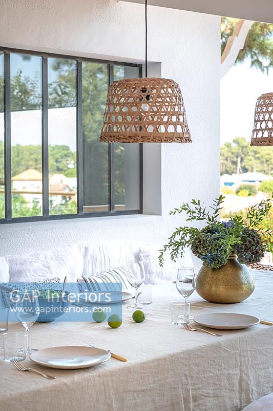 Wicker lampshade over outdoor dining table, summer 