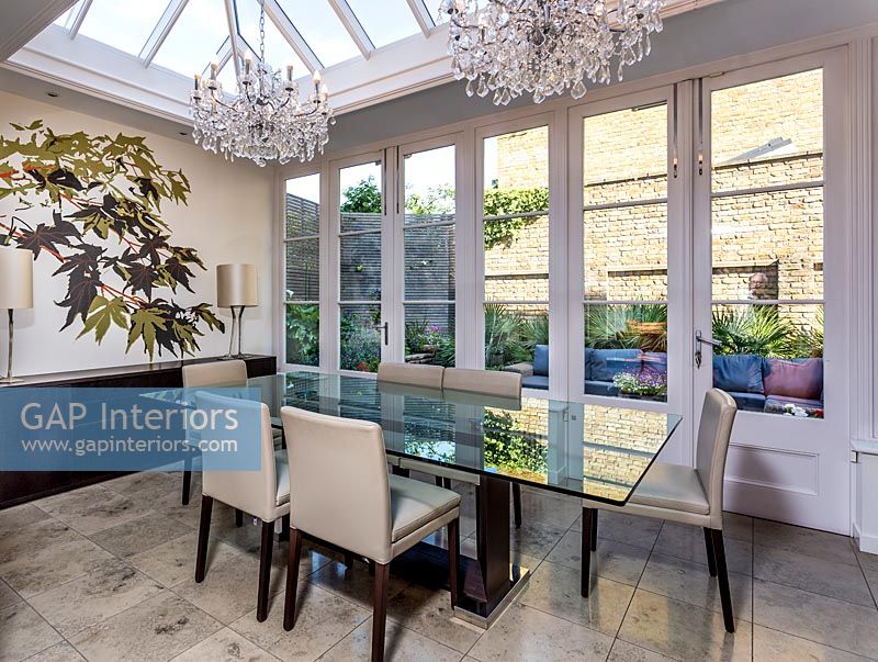 Modern dining room in glazed extension with view to patio 
