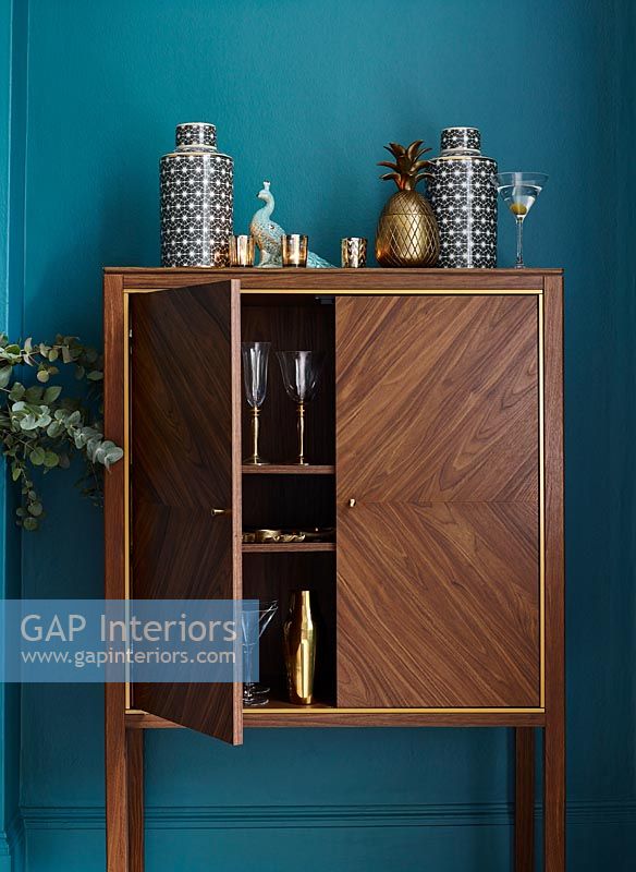 Classic wooden cabinet against blue painted wall