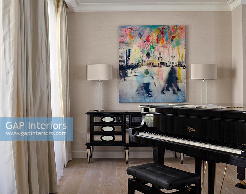 Piano and colourful painting in music room 