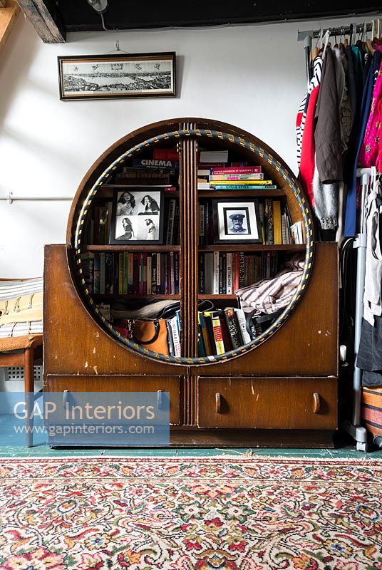 Hula hoop stored in unusual vintage wooden cabinet 