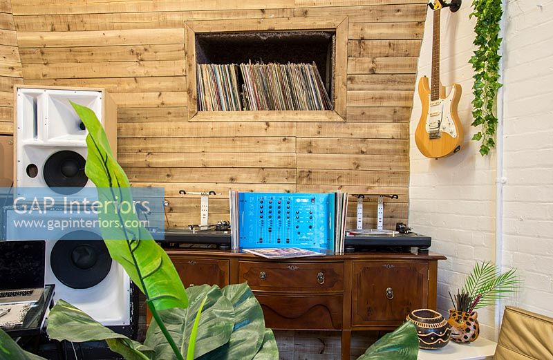 Mixing desk on sideboard in music studio 