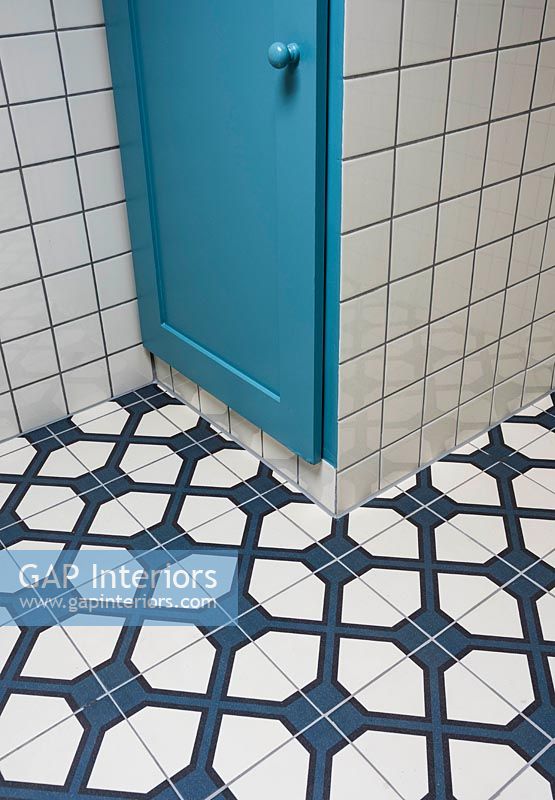 Dark blue and white patterned tiled flooring in bathroom 