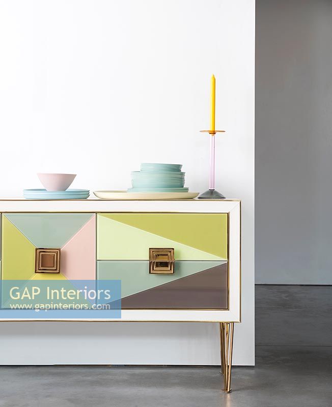Colourful modern sideboard with pastel coloured plates 