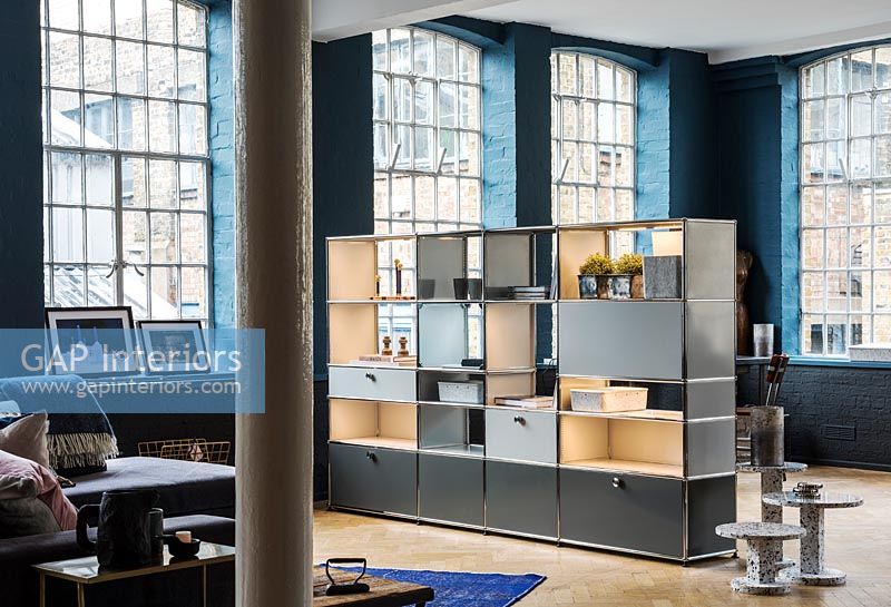Shelving unit used as divider in industrial open plan living space