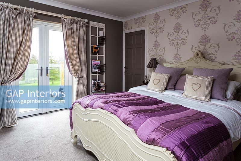 Modern bedroom with purple bedding 