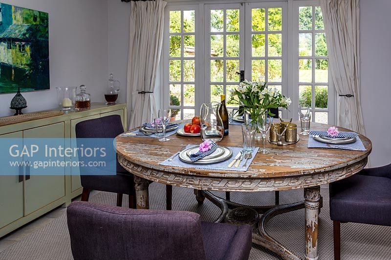 Country dining room with purple chairs 