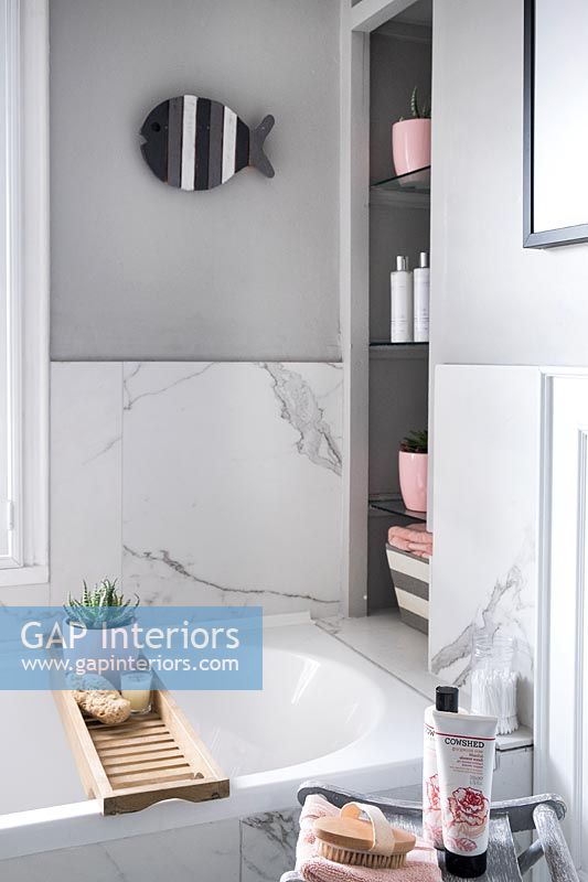 Grey modern bathroom with pink accessories 