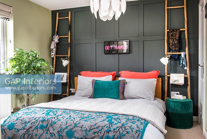 Modern bedroom with painted wood paneled wall 