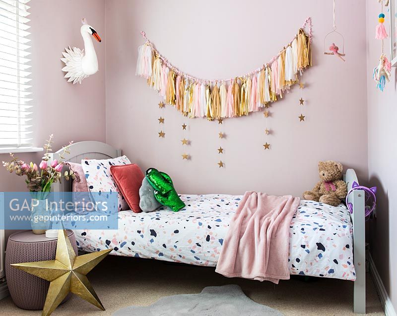 Modern childrens bedroom with tassel wall hanging 
