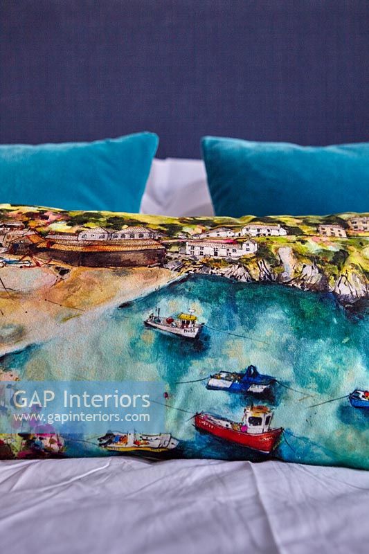 Coastal picture on cushion in modern bedroom 