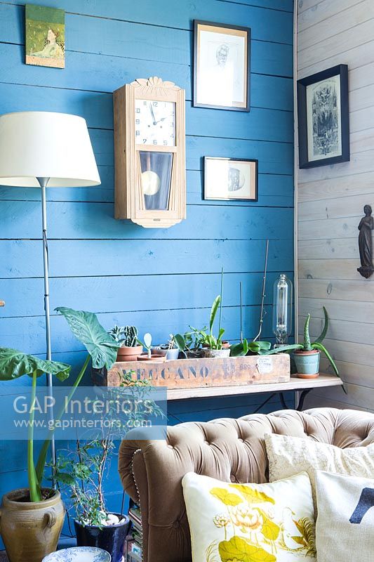 Modern living room with blue painted wooden wall 