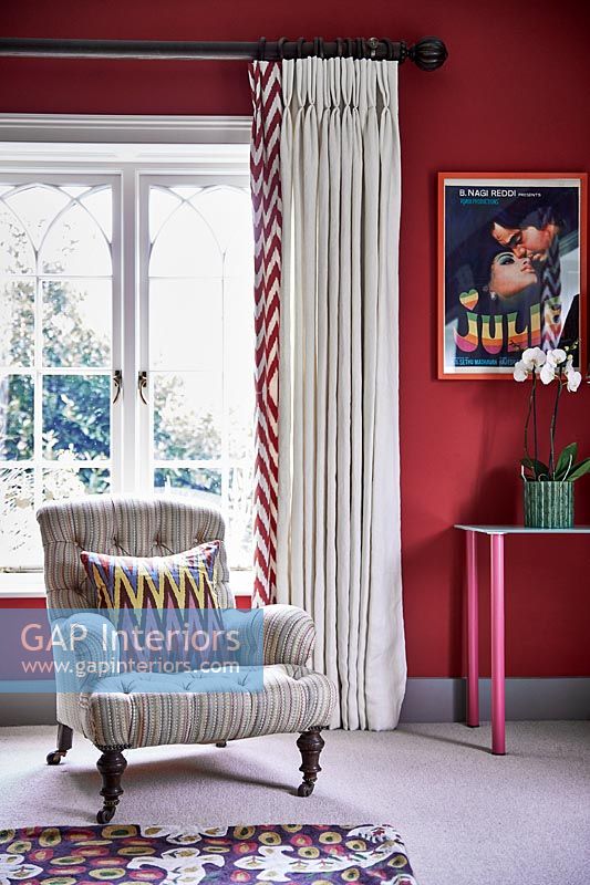 Armchair next to window in colourful living room