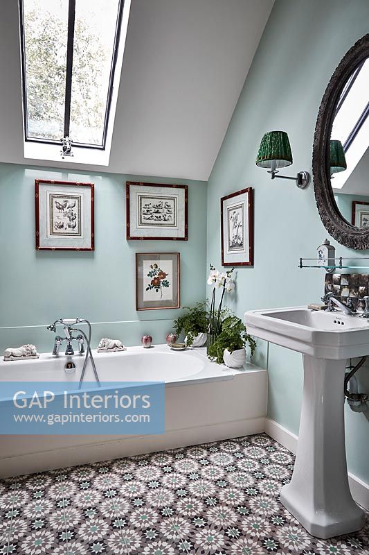 Country bathroom with pale blue painted walls and patterned floor 