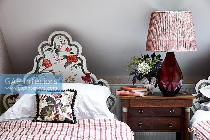Decorative floral headboard in country bedroom 