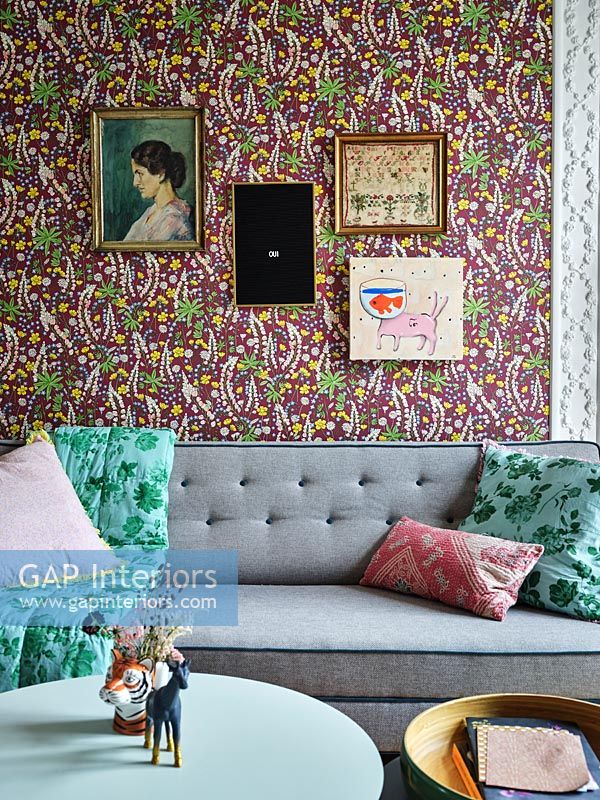 Colourful floral wallpaper and artwork on modern living room wall