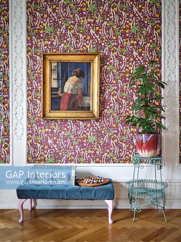 Colourful floral wallpaper and classic painting on wall 
