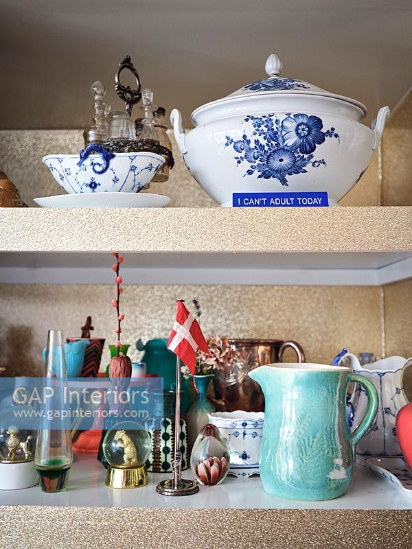 Display of ornaments and ceramics on shelves 
